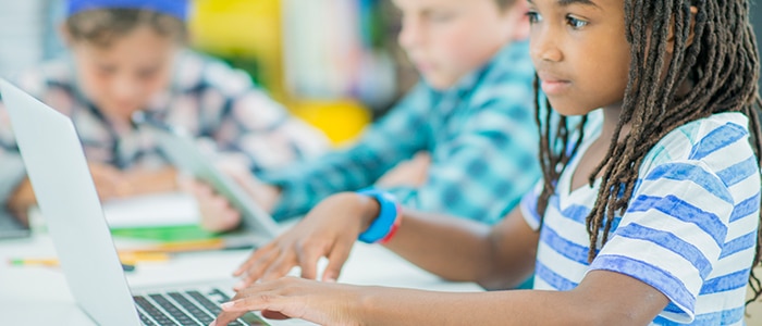 girl typing on laptop